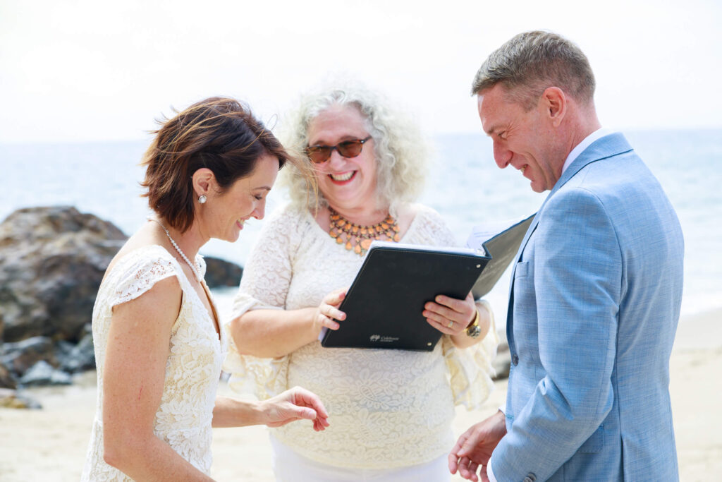 Wedding officiant Mitzi Schwarz with couple during wedding ceremony